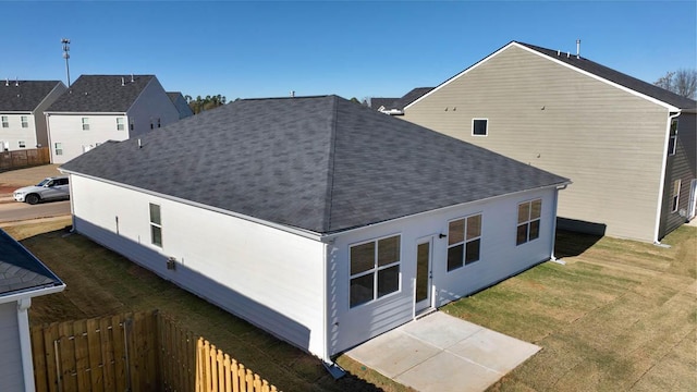 back of property with a patio area and a lawn