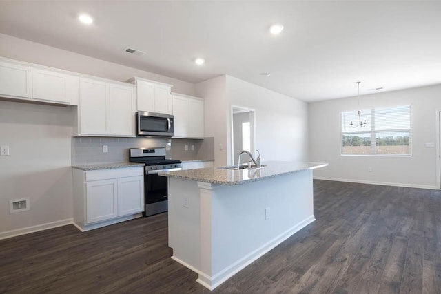 kitchen featuring sink, stainless steel appliances, dark hardwood / wood-style flooring, a kitchen island with sink, and white cabinets