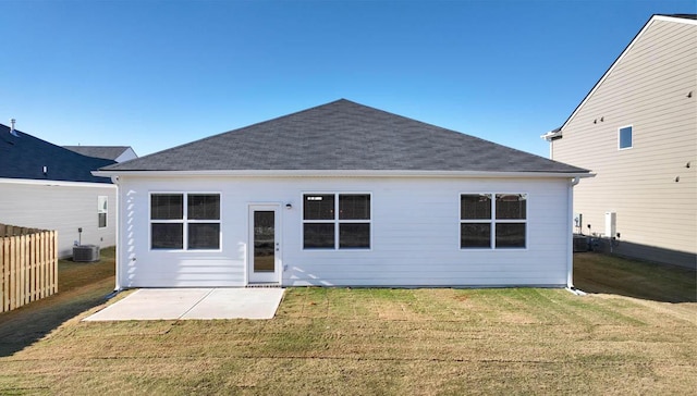 back of house featuring a lawn, a patio area, and central AC