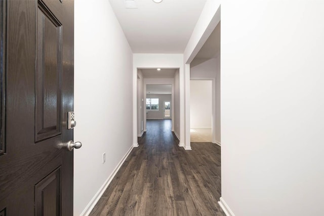 hall with dark wood-type flooring