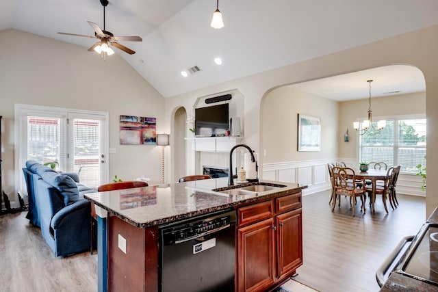 2306 Peach Blossom Pass, Hephzibah, GA 30815 - kitchen with black appliances, open floor plan, arched walkways, a wainscoted wall, and high vaulted ceiling