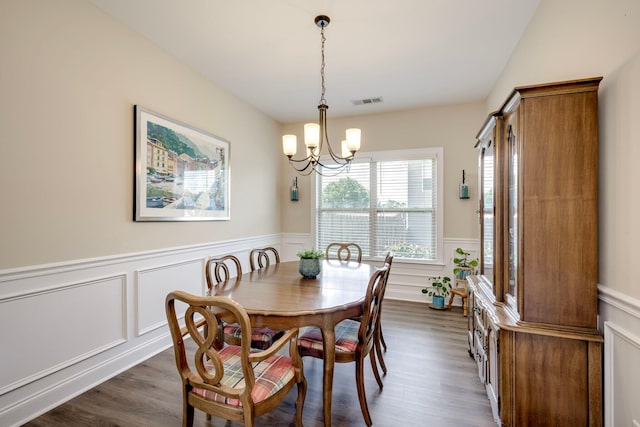 2306 Peach Blossom Pass, Hephzibah, GA 30815 - dining room with a chandelier, a wainscoted wall, dark wood-style floors, and a decorative wall
