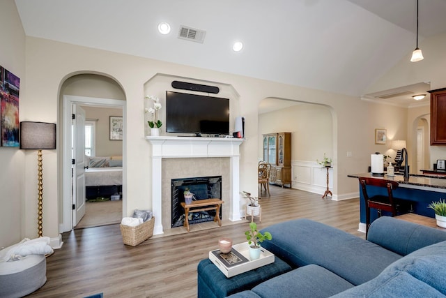 2306 Peach Blossom Pass, Hephzibah, GA 30815 - living room with arched walkways, light wood-style flooring, a fireplace, and recessed lighting