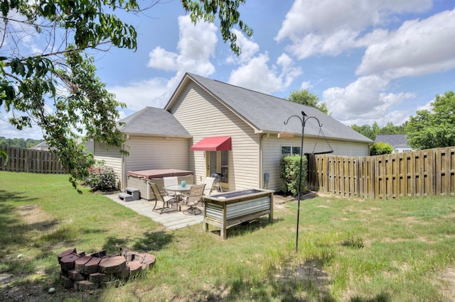 2306 Peach Blossom Pass, Hephzibah, GA 30815 - rear view of property featuring a hot tub, a fire pit, and a patio area
