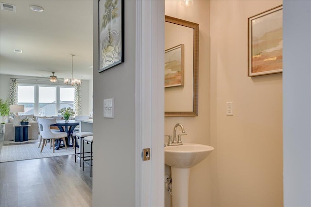 bathroom with wood-type flooring and ceiling fan