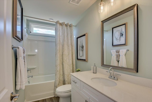 full bathroom with hardwood / wood-style floors, vanity, toilet, and shower / bath combo with shower curtain