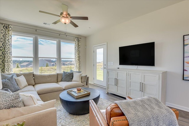 living room with ceiling fan and hardwood / wood-style flooring