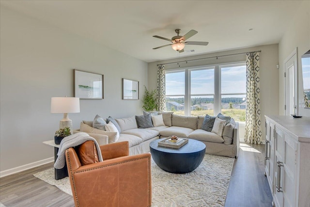 living room with hardwood / wood-style flooring and ceiling fan