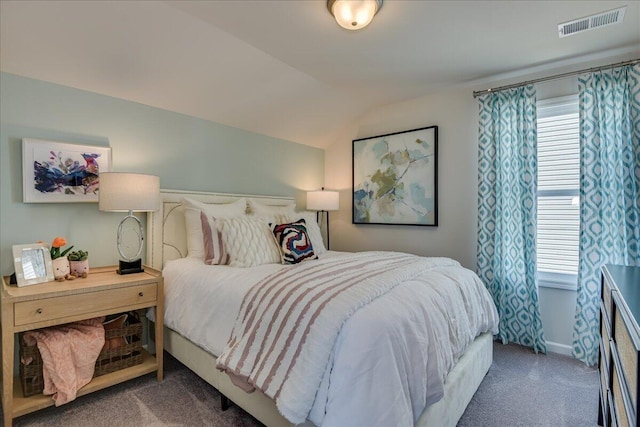 bedroom featuring dark carpet and vaulted ceiling