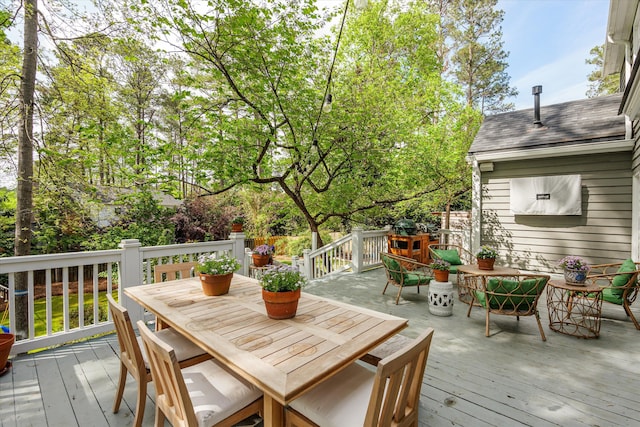 wooden deck with outdoor dining space