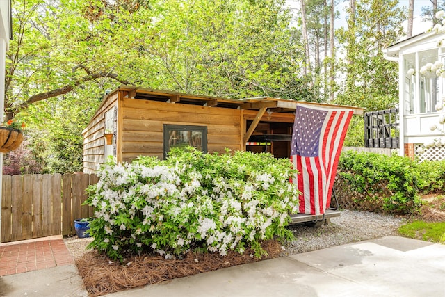 view of outbuilding featuring fence