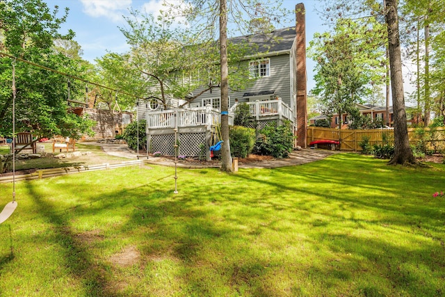 view of yard with fence and a wooden deck