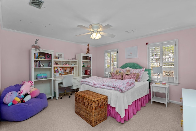 carpeted bedroom with baseboards, ornamental molding, ceiling fan, and visible vents