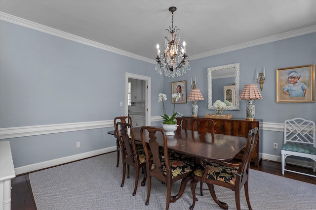 dining area with baseboards, an inviting chandelier, ornamental molding, and wood finished floors