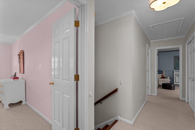 corridor featuring baseboards, carpet, attic access, and an upstairs landing