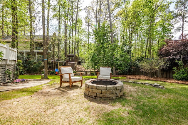 view of yard featuring fence and a fire pit