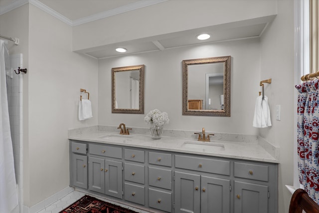 bathroom with crown molding, double vanity, curtained shower, and a sink