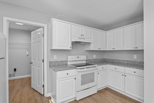 kitchen featuring a textured ceiling, dark hardwood / wood-style floors, electric range, white cabinets, and light stone countertops