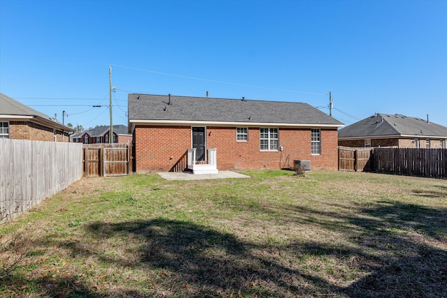 rear view of house with a yard