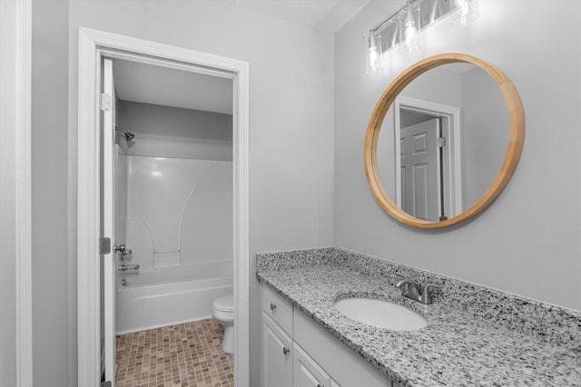 full bathroom featuring vanity, bathing tub / shower combination, toilet, and a textured ceiling