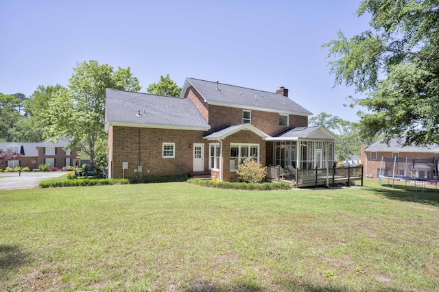 467 Baker Woods Trl, Martinez, GA 30907 - rear view of house with a trampoline, brick siding, a sunroom, a chimney, and a lawn