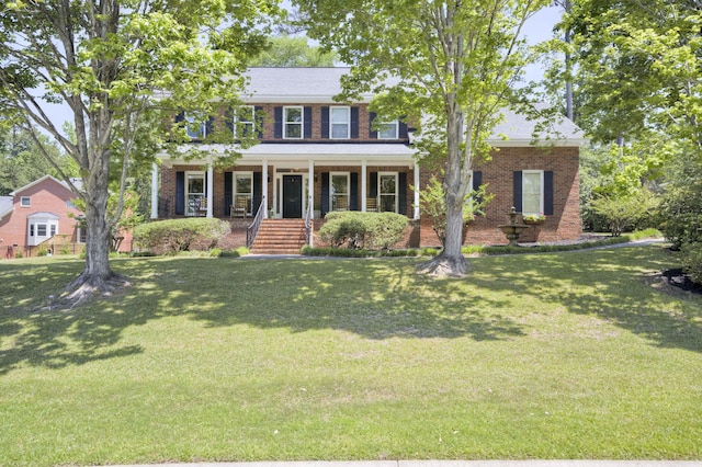 467 Baker Woods Trl, Martinez, GA 30907 - colonial house with covered porch, brick siding, and a front lawn