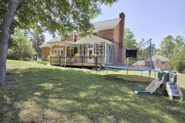 467 Baker Woods Trl, Martinez, GA 30907 - back of property featuring a yard, a deck, a chimney, and a trampoline
