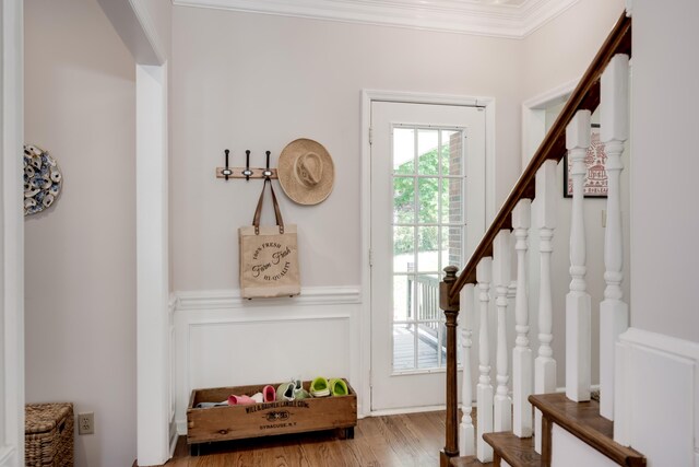 467 Baker Woods Trl, Martinez, GA 30907 - entrance foyer featuring wainscoting, wood finished floors, ornamental molding, a decorative wall, and stairs