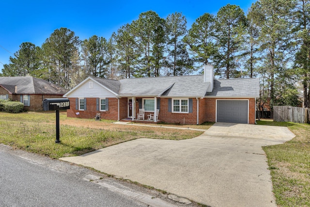 ranch-style home featuring brick siding, concrete driveway, a garage, and fence