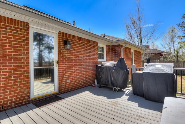 deck with area for grilling and fence