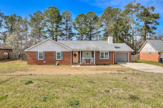 single story home with an attached garage, fence, brick siding, and driveway