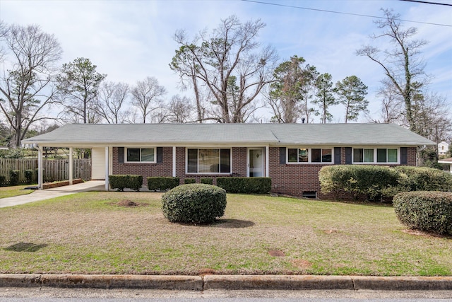 ranch-style home featuring a front yard and a carport