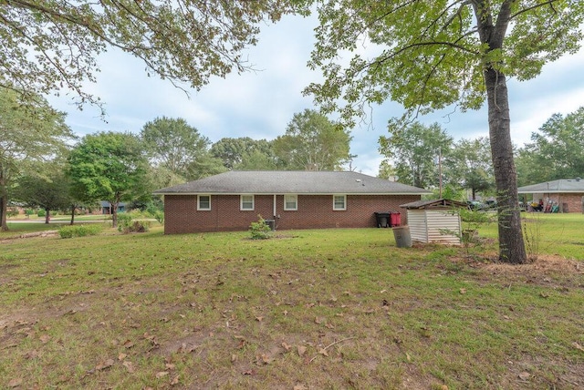 153 Campbell Cir, Hephzibah, GA 30815 - back of property featuring a shed, a lawn, and brick siding