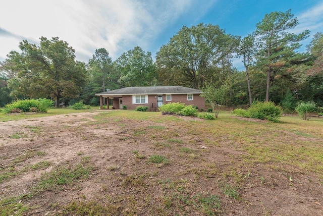 153 Campbell Cir, Hephzibah, GA 30815 - single story home featuring a front lawn, a carport, brick siding, and a view of trees