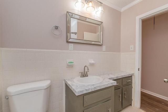 153 Campbell Cir, Hephzibah, GA 30815 - bathroom featuring ornamental molding, vanity, wood finished floors, tile walls, and a wainscoted wall