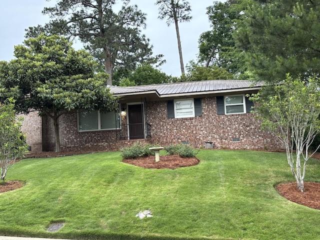 ranch-style house featuring brick siding, a front yard, metal roof, and crawl space