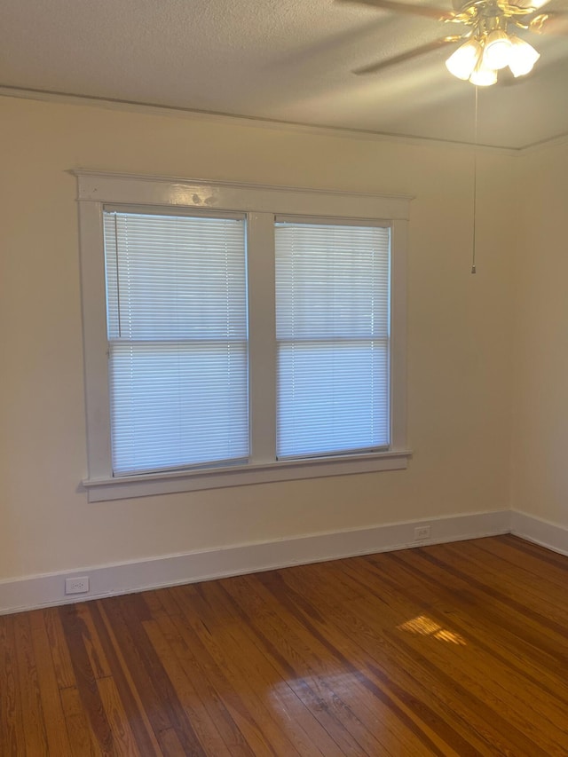 unfurnished room with wood-type flooring, a textured ceiling, and ceiling fan