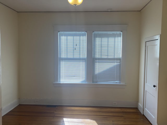 spare room featuring dark hardwood / wood-style flooring