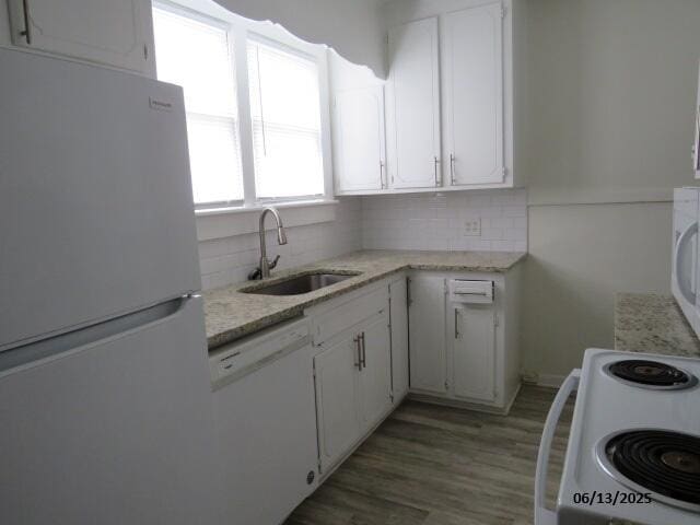 1642 Whitney St, Augusta, GA 30904 - kitchen with white appliances, tasteful backsplash, and white cabinetry