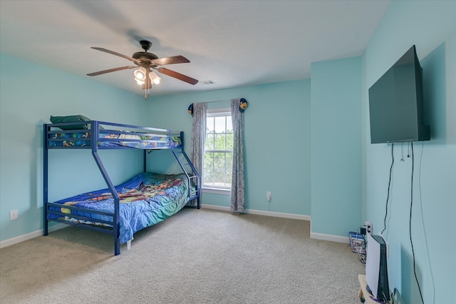 carpeted bedroom featuring baseboards, ceiling fan, and visible vents