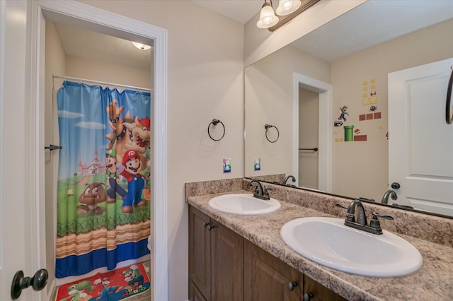 full bath with double vanity, a sink, and a shower with curtain