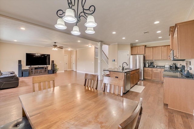 dining space featuring crown molding, ceiling fan, recessed lighting, light wood-type flooring, and ornate columns