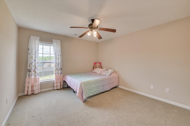 carpeted bedroom featuring baseboards, ceiling fan, and visible vents