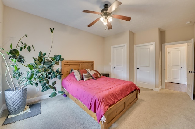 bedroom with baseboards, light carpet, and ceiling fan