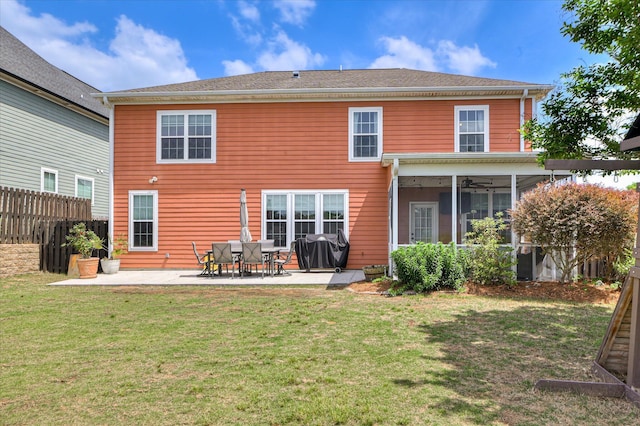 back of house with ceiling fan, fence, a sunroom, a patio area, and a lawn