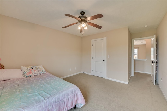 carpeted bedroom with baseboards and a ceiling fan