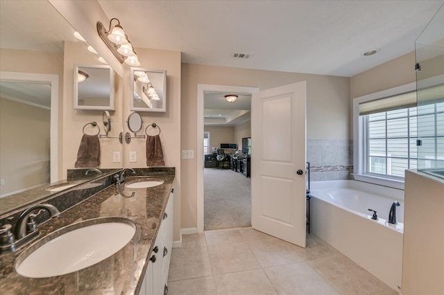 bathroom with visible vents, a sink, a garden tub, and tile patterned flooring