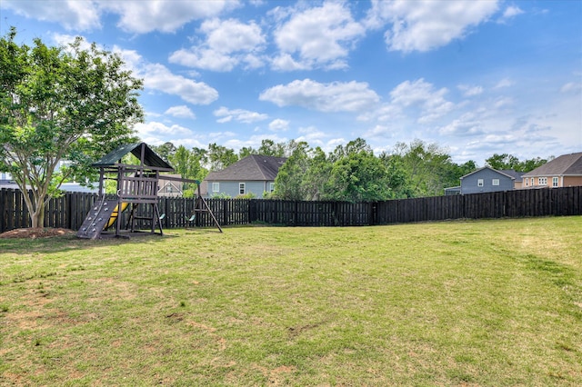 view of yard featuring a playground and a fenced backyard