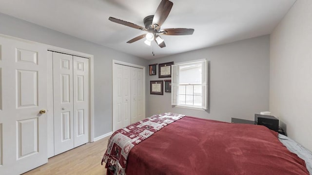 50 Bluff Pointe Way, Aiken, SC 29803 - bedroom featuring two closets, light wood-type flooring, and a ceiling fan