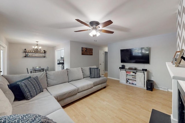 50 Bluff Pointe Way, Aiken, SC 29803 - living room with a chandelier, a ceiling fan, light wood-style flooring, and baseboards